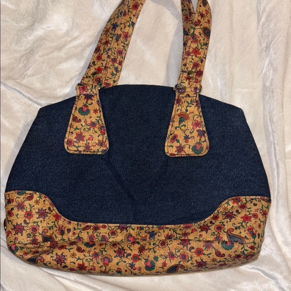 BLUE DENIM HANDBAG WITH FLORAL CORKLIKE DESIGN ON BOTTOM & HANDLES RED INTERIOR